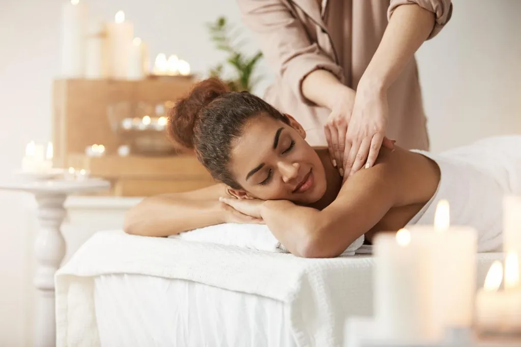 tender-african-woman-smiling-enjoying-massage-with-closed-eyes-spa-resort-scaled.jpg